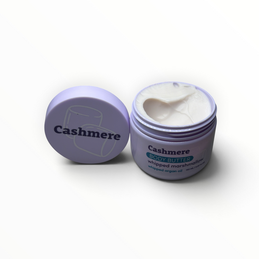 Open jar of Cashmere Whipped Marshmallow Argan Oil Body Butter showing whipped texture